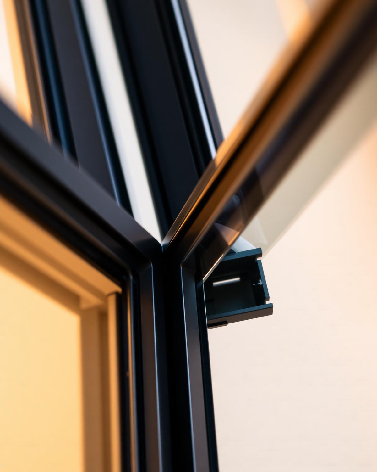 Close-up of an installed impact window frame with full-perimeter caulking
